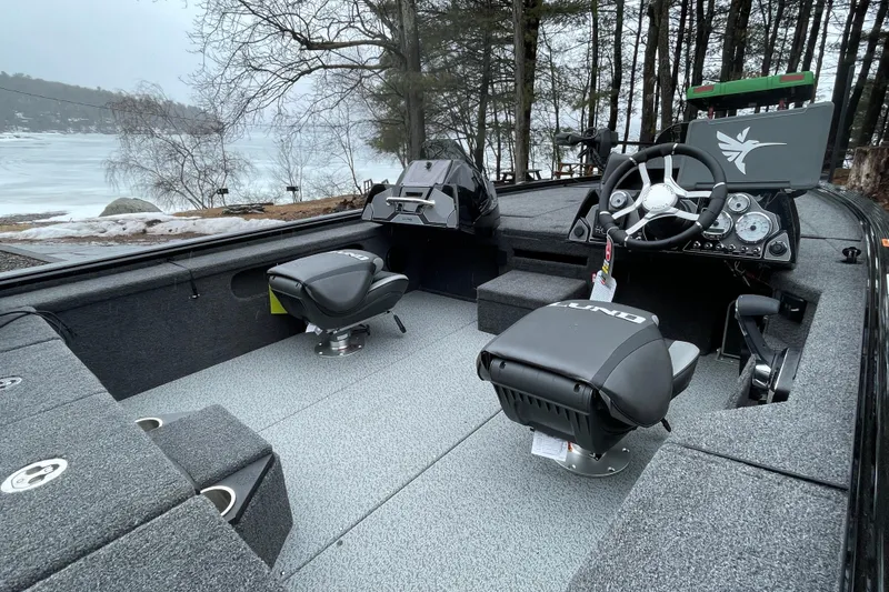 Slide: The Image of 2026 Lund 2075 Pro-V Bass XS boat interior with dual seats and steering console. - 11