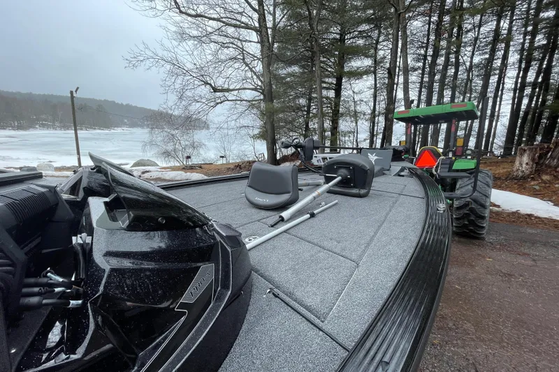 Slide: The Image of 2026 Lund 2075 Pro-V Bass XS boat on snowy lakeside, with tractor in background. - 3