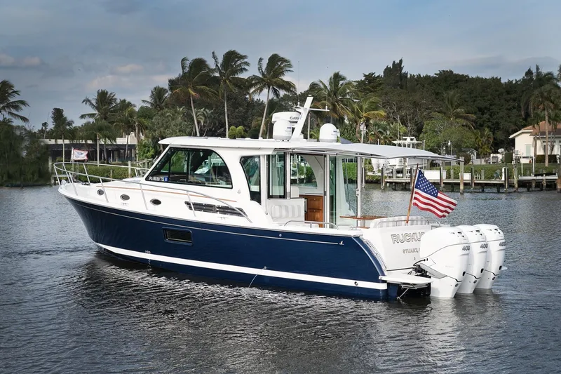 Slide: The Image of 2023 Back Cove 39O boat with triple engines on a scenic waterway. - 2