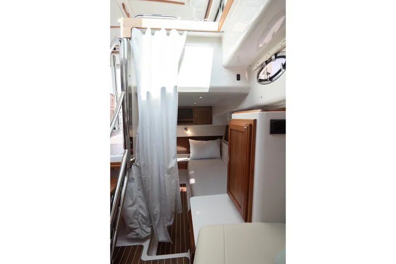 Slide: The Image of Interior cabin of 2023 Back Cove 39O boat, featuring cozy bed and wooden cabinetry. - 21