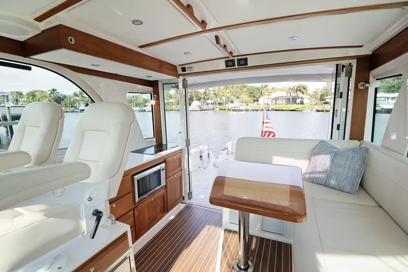 Slide: The Image of Luxurious interior of 2023 Back Cove 39O yacht with seating, table, and waterfront view. - 25