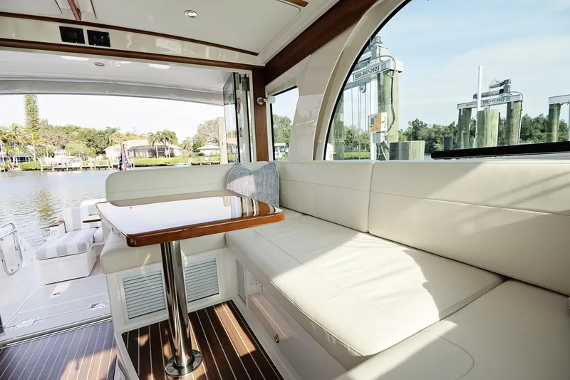 Slide: The Image of Luxurious interior of 2023 Back Cove 39O yacht with elegant seating and scenic water view. - 26
