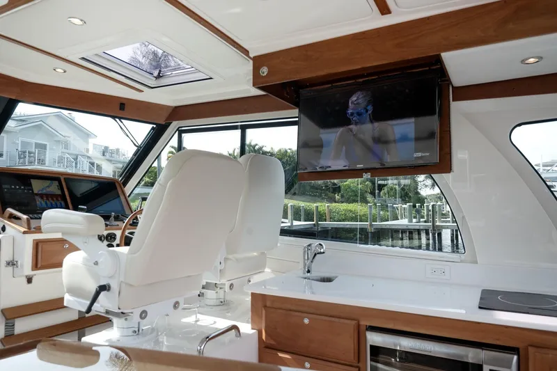 Slide: The Image of Interior of 2023 Back Cove 39O yacht with helm, seating, and TV. - 29