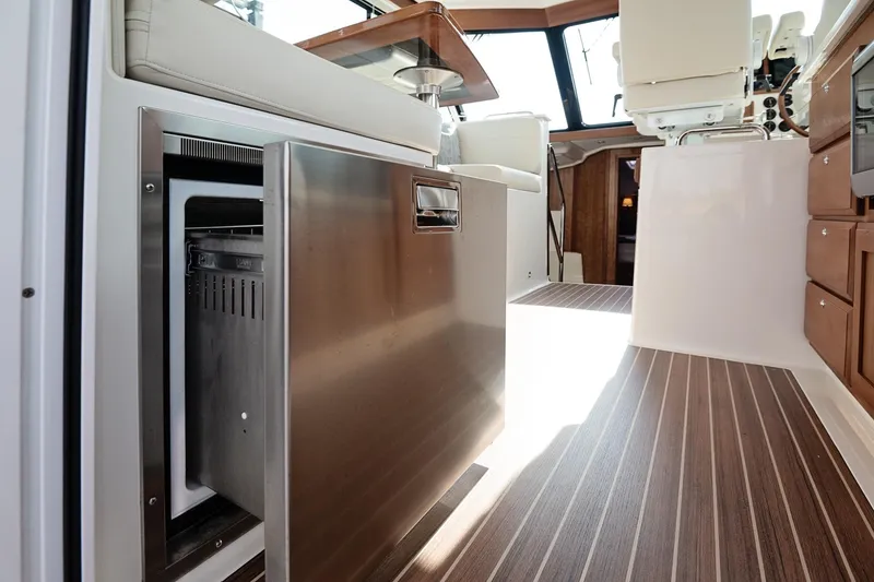 Slide: The Image of 2023 Back Cove 39O yacht interior with open stainless steel drawer and wood flooring. - 32