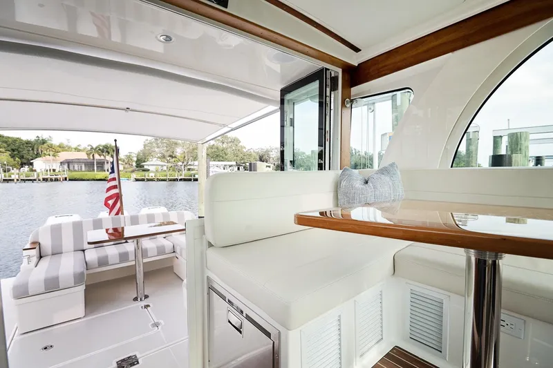 Slide: The Image of 2023 Back Cove 39O yacht interior with elegant seating and waterfront view. - 33
