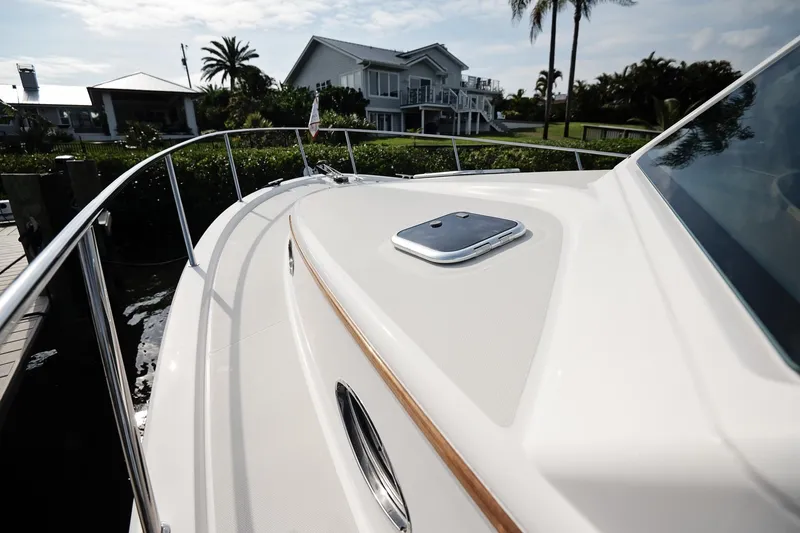 Slide: The Image of 2023 Back Cove 39O yacht deck with railing, docked near waterfront homes. - 46