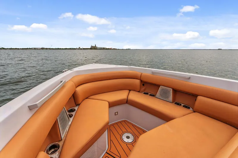 Slide: The Image of 2021 Aviara AV36 OB boat with orange seating, overlooking calm waters and distant shoreline. - 10