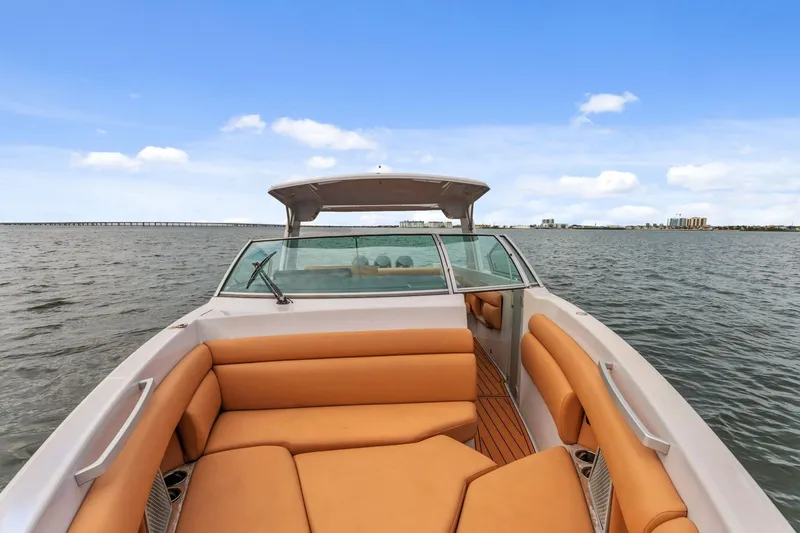 Slide: The Image of 2021 Aviara AV36 OB boat with tan seating, cruising on open water under blue skies. - 11