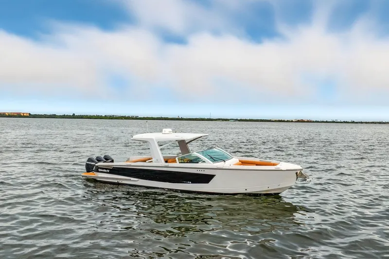 Slide: The Image of 2021 Aviara AV36 OB boat on calm water under a blue sky. - 2