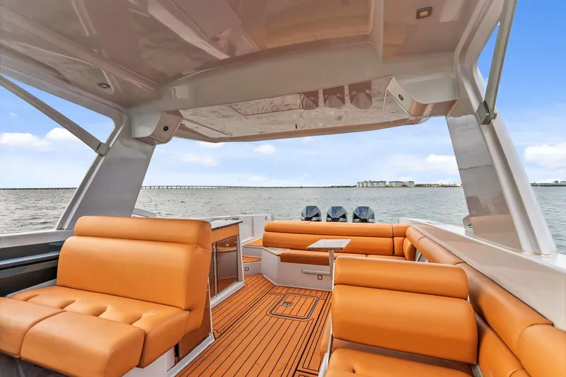Slide: The Image of 2021 Aviara AV36 OB luxury boat interior with tan seating and scenic water view. - 22