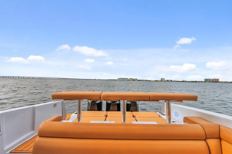 Slide: The Image of 2021 Aviara AV36 OB boat with orange seating, cruising on open water under a clear sky. - 24