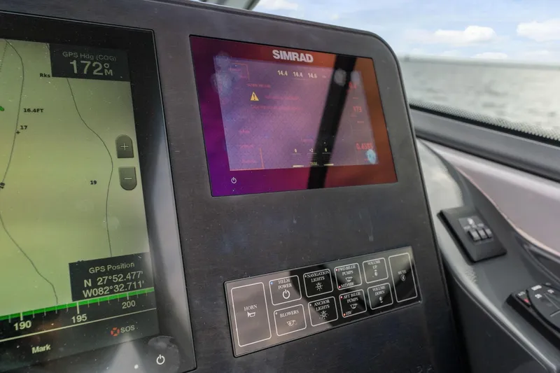 Slide: The Image of Dashboard of 2021 Aviara AV36 OB boat with navigation screens and controls. - 35