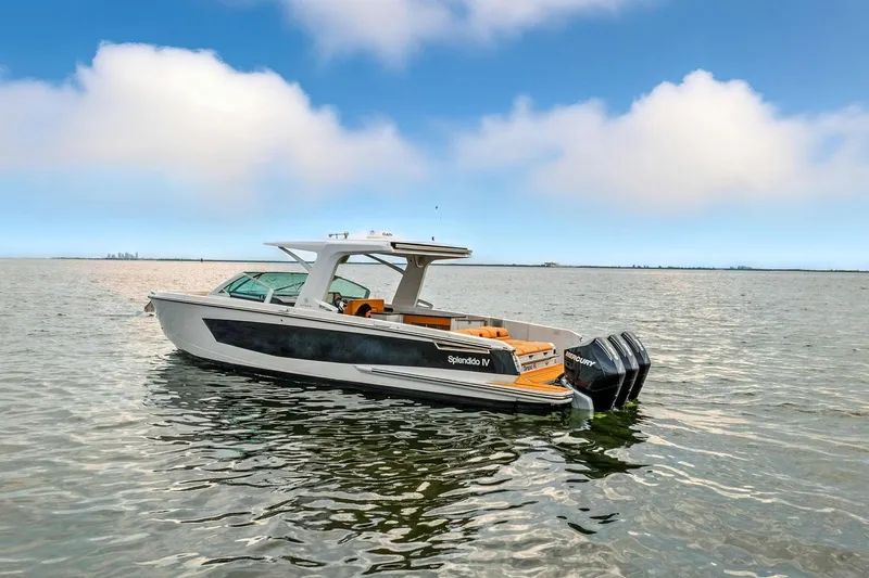 Slide: The Image of 2021 Aviara AV36 OB boat on calm water under a clear blue sky. - 5