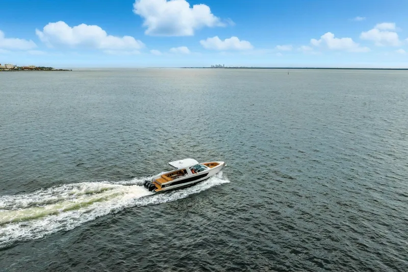 Slide: The Image of Aviara AV36 OB 2021 cruising on open water under a clear blue sky. - 6