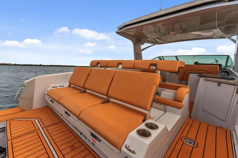 Slide: The Image of 2021 Aviara AV36 OB boat with orange seating and teak flooring on open water. - 9