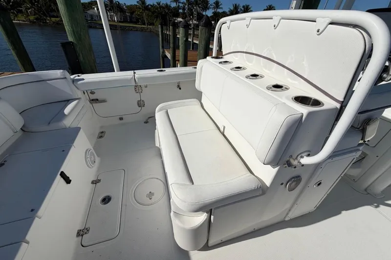 Slide: The Image of 2019 Sea Hunt Ultra 275 SE boat interior with white seating and cup holders. - 10