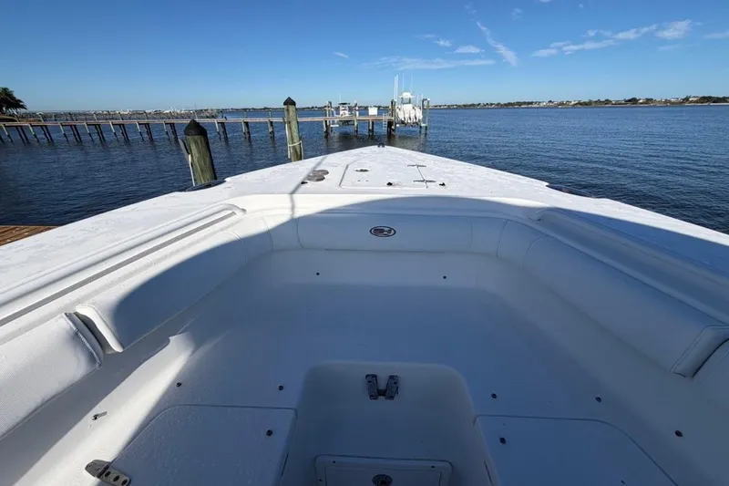 Slide: The Image of 2019 Sea Hunt Ultra 275 SE boat interior with waterfront view. - 12