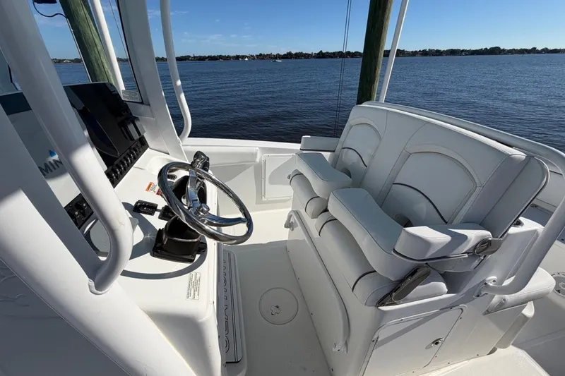 Slide: The Image of 2019 Sea Hunt Ultra 275 SE boat interior with steering wheel and seating. - 8