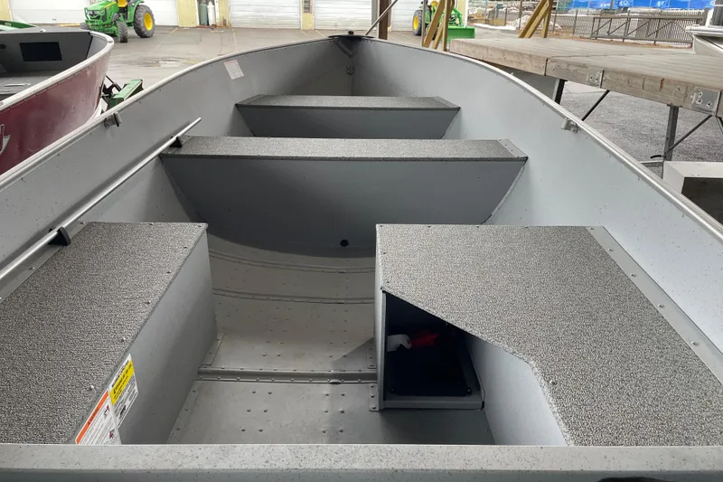 Slide: The Image of 2026 Lund WC-14 boat interior with seating and storage compartments. - 10