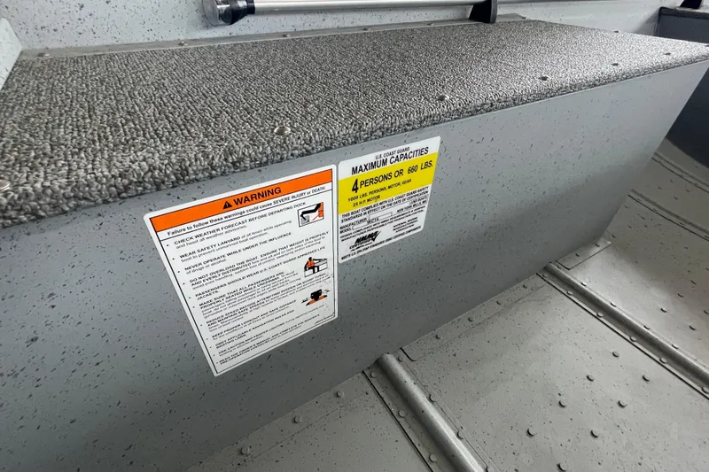 Slide: The Image of 2026 Lund WC-14 boat interior with warning and capacity labels. - 22