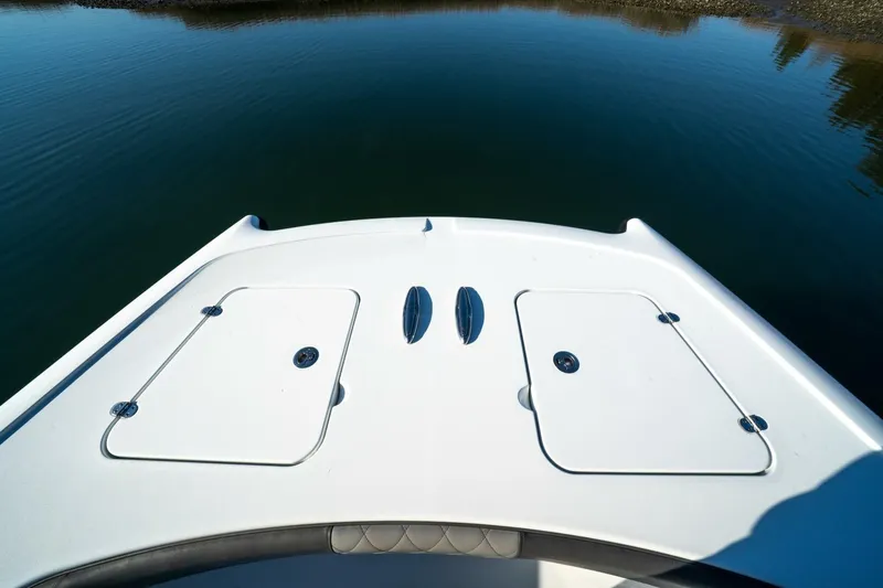 Slide: The Image of Bow of 2024 Freeman 38 boat on calm water, featuring storage hatches. - 13