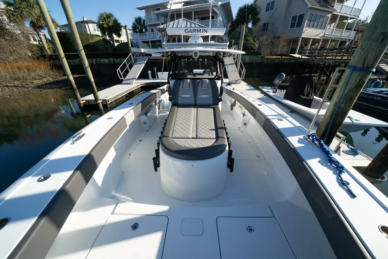 Slide: The Image of 2024 Freeman 38 boat with spacious deck, docked near waterfront homes. - 16