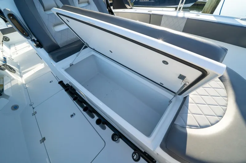 Slide: The Image of Open storage compartment on 2024 Freeman 38 boat with cushioned seating. - 18
