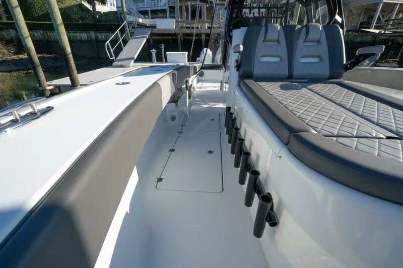 Slide: The Image of 2024 Freeman 38 boat interior with cushioned seating and rod holders. - 19