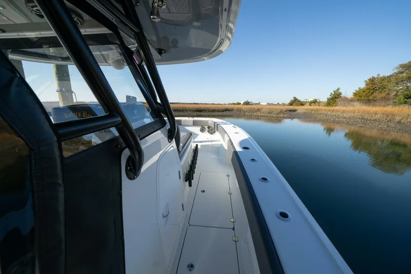 Slide: The Image of 2024 Freeman 38 boat navigating calm waters with clear blue sky. - 24