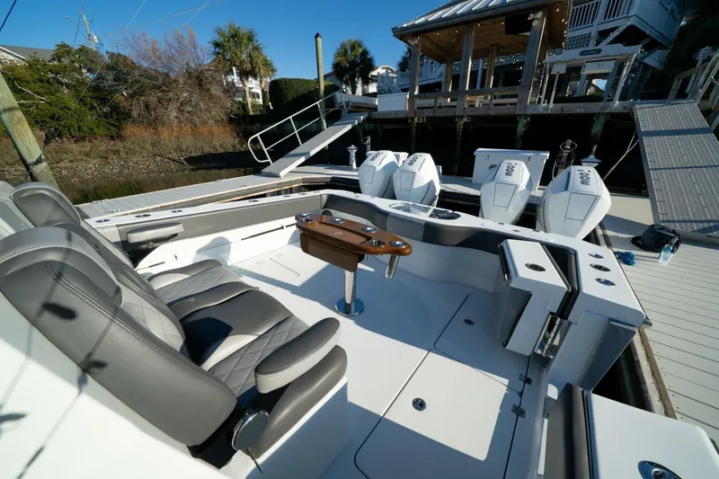 Slide: The Image of 2024 Freeman 38 boat interior with seating and powerful outboard engines at dock. - 31