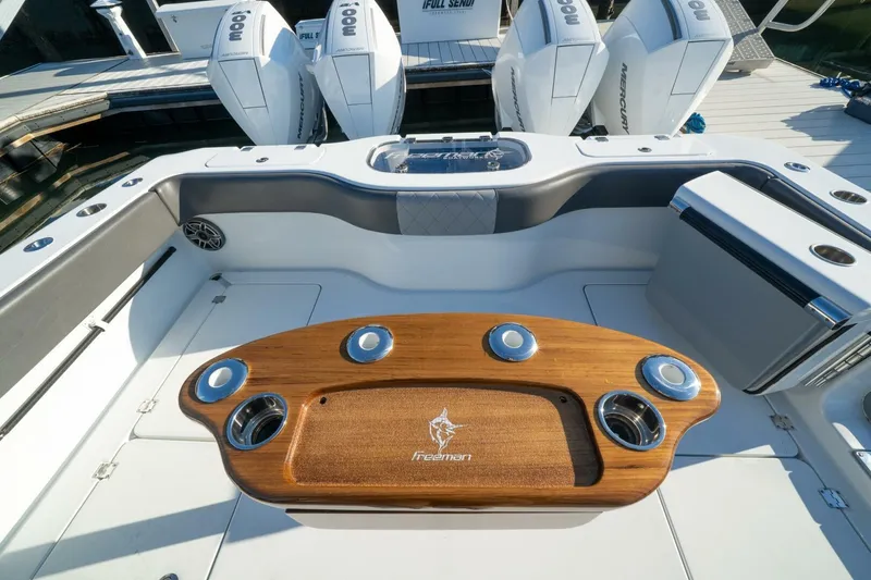 Slide: The Image of 2024 Freeman 38 boat interior with wooden table and Mercury engines. - 35