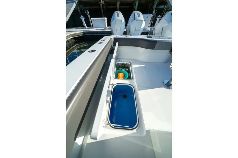 Slide: The Image of 2024 Freeman 38 boat deck with storage compartments and outboard motors. - 36