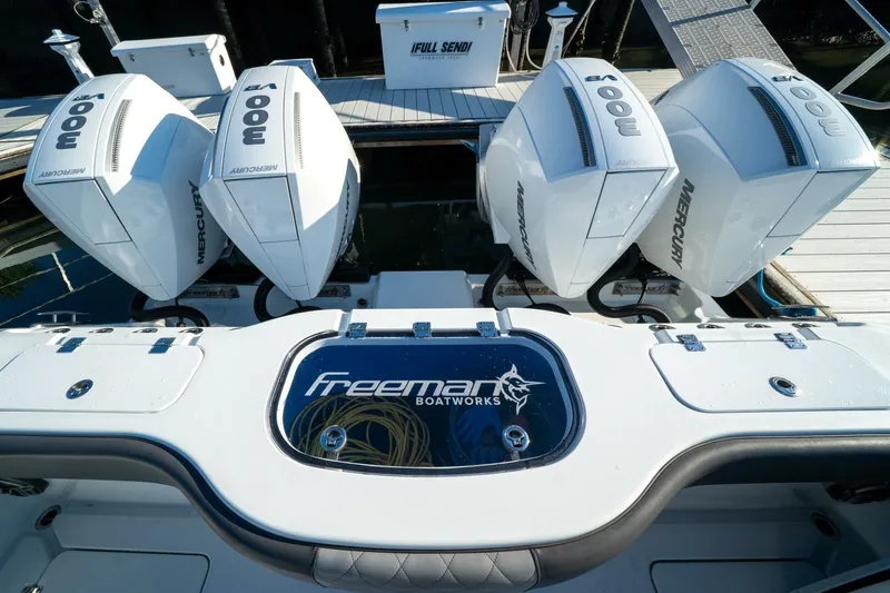 Slide: The Image of 2024 Freeman 38 boat with four powerful Mercury outboard engines at the dock. - 37