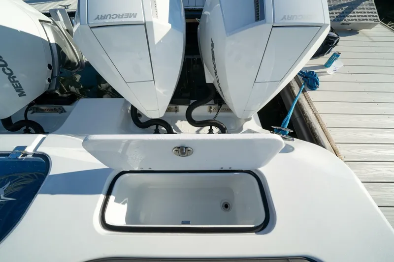 Slide: The Image of 2024 Freeman 38 boat with dual Mercury outboard engines at dock. - 39