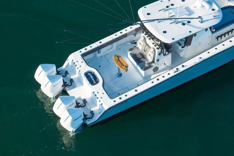 Slide: The Image of 2024 Freeman 38 boat with dual Mercury engines on calm water. - 42