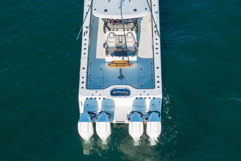 Slide: The Image of 2024 Freeman 38 boat with triple engines on clear blue water. - 43