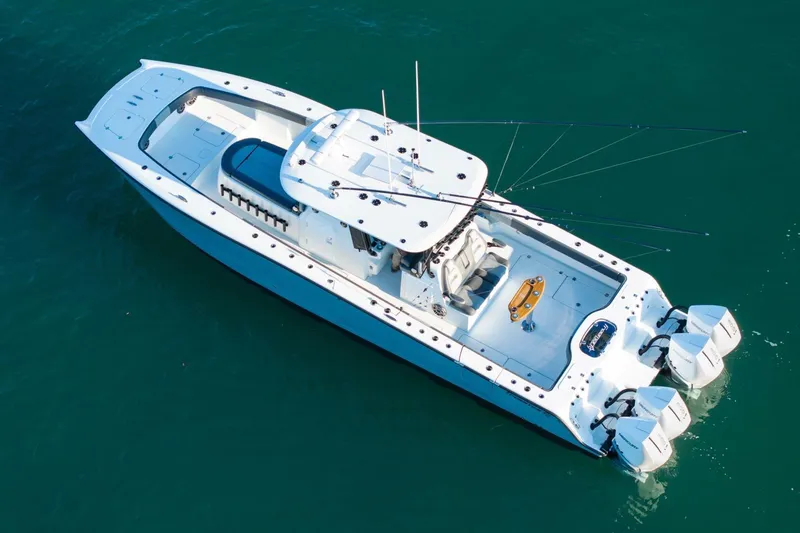 Slide: The Image of 2024 Freeman 38 boat with triple outboard engines on clear water. - 44