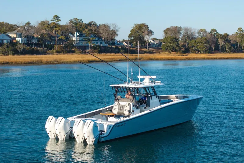 Slide: The Image of 2024 Freeman 38 boat on calm water near a scenic shoreline. - 9
