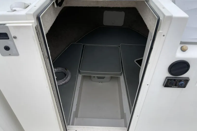 Slide: The Image of 2014 Parker 2310 DV Walkaround cabin interior with seating and storage. - 13