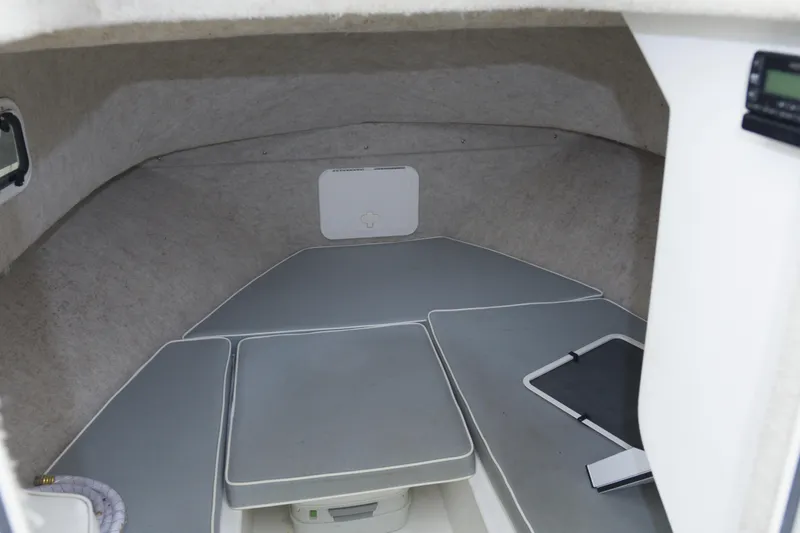 Slide: The Image of 2014 Parker 2310 DV Walkaround cabin interior with cushioned seating and storage. - 15