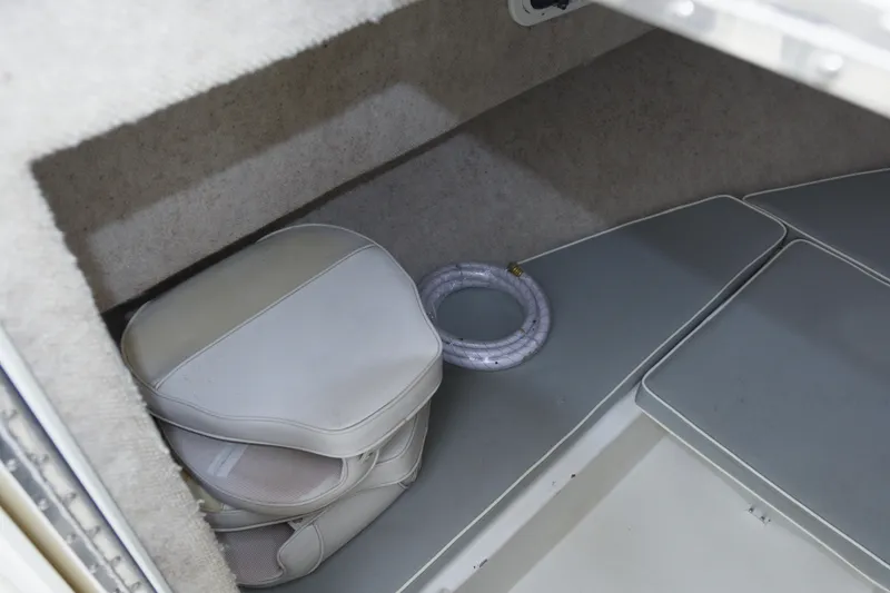 Slide: The Image of Interior of 2014 Parker 2310 DV Walkaround boat with cushions and coiled rope. - 16