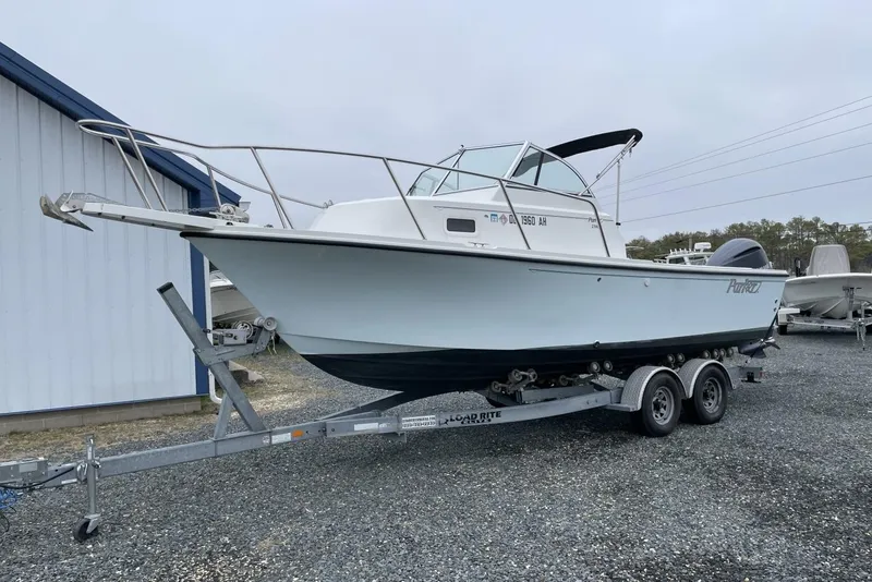 Slide: The Image of 2014 Parker 2310 DV Walkaround boat on trailer, parked outdoors. - 3