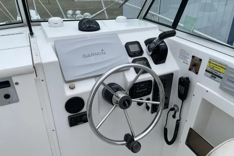 Slide: The Image of 2014 Parker 2310 DV Walkaround boat helm with Garmin navigation system and steering wheel. - 8