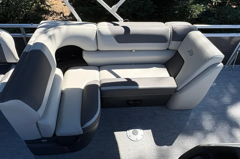Slide: The Image of 2026 Sun Tracker Fishin' Barge 20 DLX interior seating, featuring plush, gray upholstery. - 14