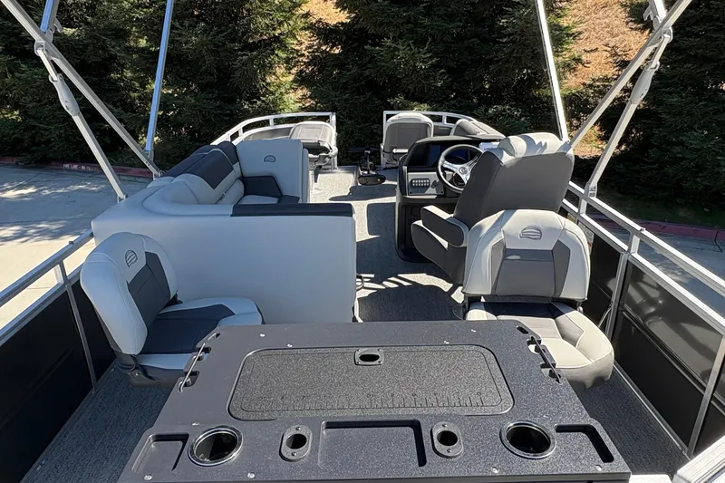 Slide: The Image of 2026 Sun Tracker Fishin' Barge 20 DLX interior with seating and steering console. - 13