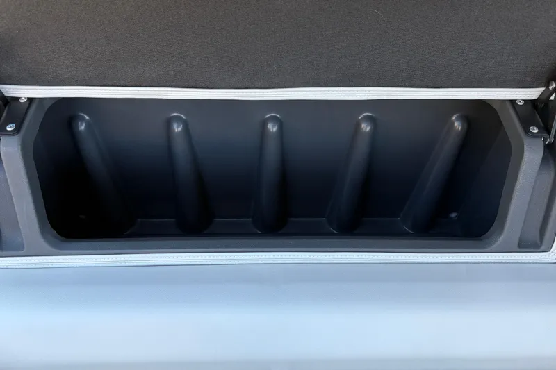 Slide: The Image of Storage compartment of 2026 Sun Tracker Fishin' Barge 20 DLX, featuring rod holders. - 32
