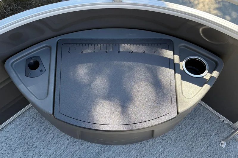 Slide: The Image of 2026 Sun Tracker Fishin' Barge 20 DLX fishing station with ruler and cup holder. - 18