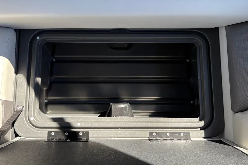 Slide: The Image of 2026 Sun Tracker Fishin' Barge 20 DLX storage compartment, open and empty. - 29