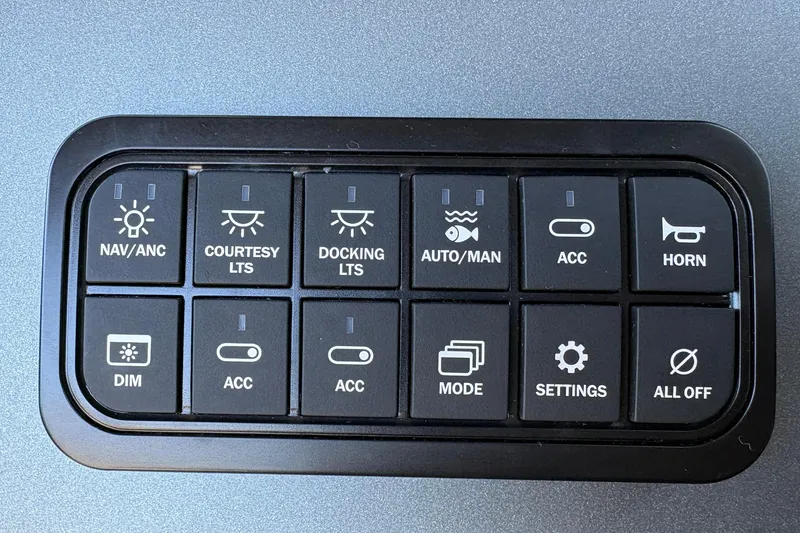 Slide: The Image of Control panel of 2026 Sun Tracker Fishin' Barge 20 DLX with various function buttons. - 132