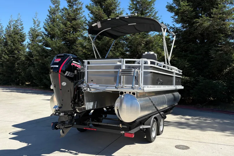 Slide: The Image of 2026 Sun Tracker Fishin' Barge 20 DLX pontoon boat with Mercury 115 engine on trailer. - 10